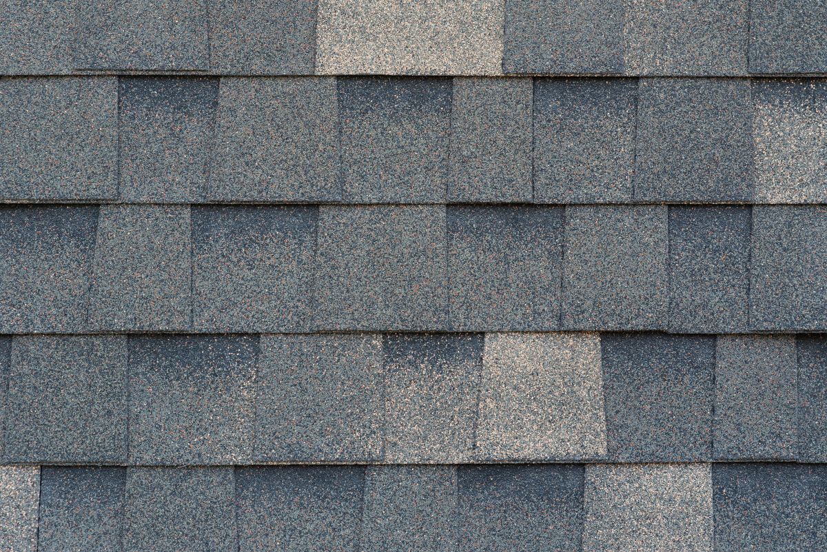 Close-up texture of dark gray asphalt roofing shingles, St Paul, MN