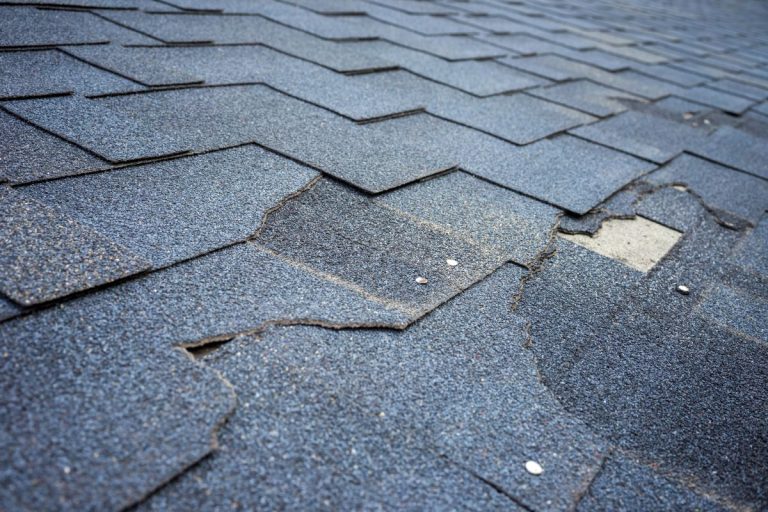 close-up damaged shingles in St Paul