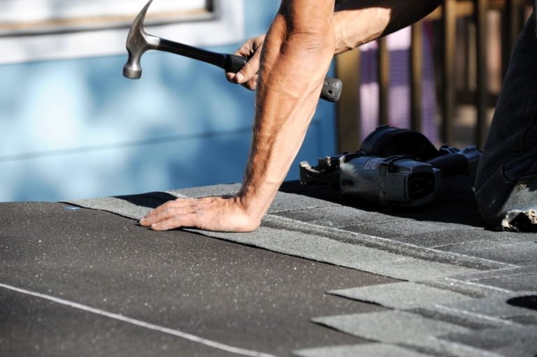 handyman working on repairing roof, St Paul